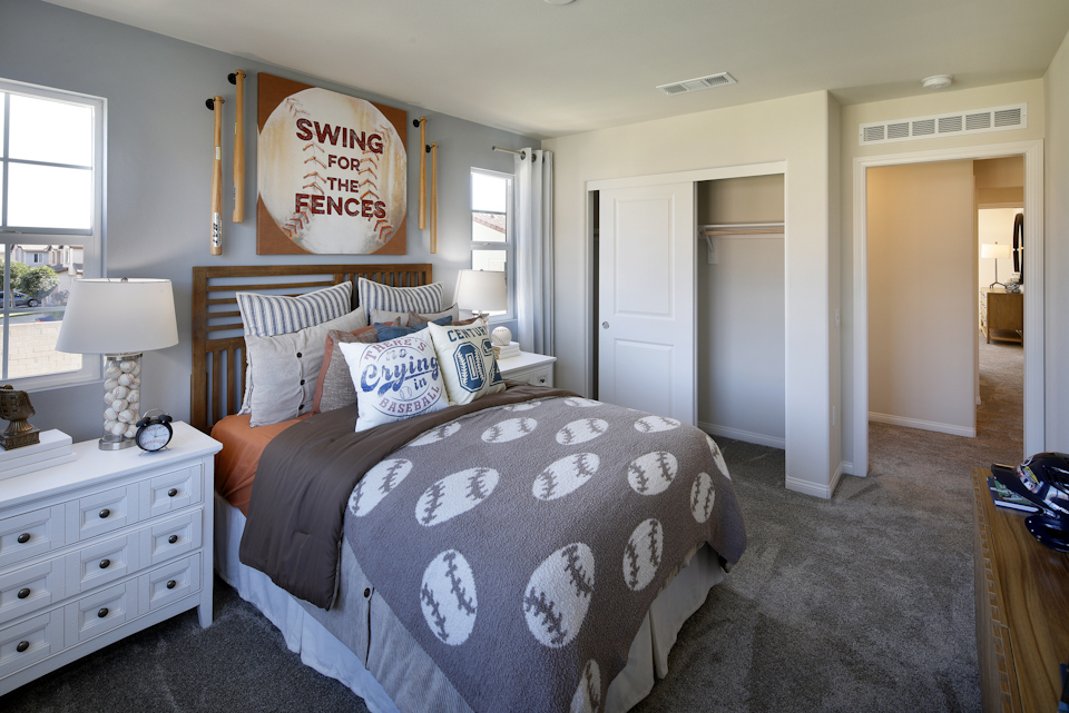 A bedroom with a bed and a dresser.