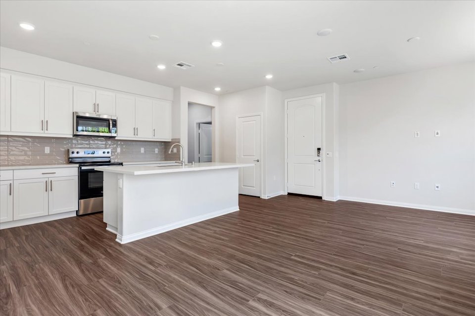 A kitchen with white cabinets.