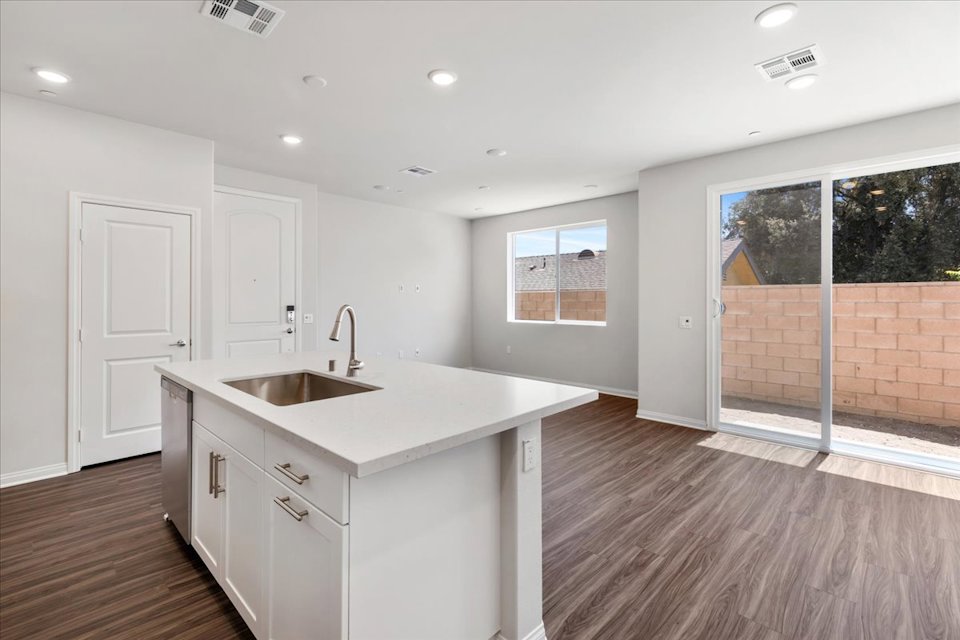 A kitchen with white cabinets.