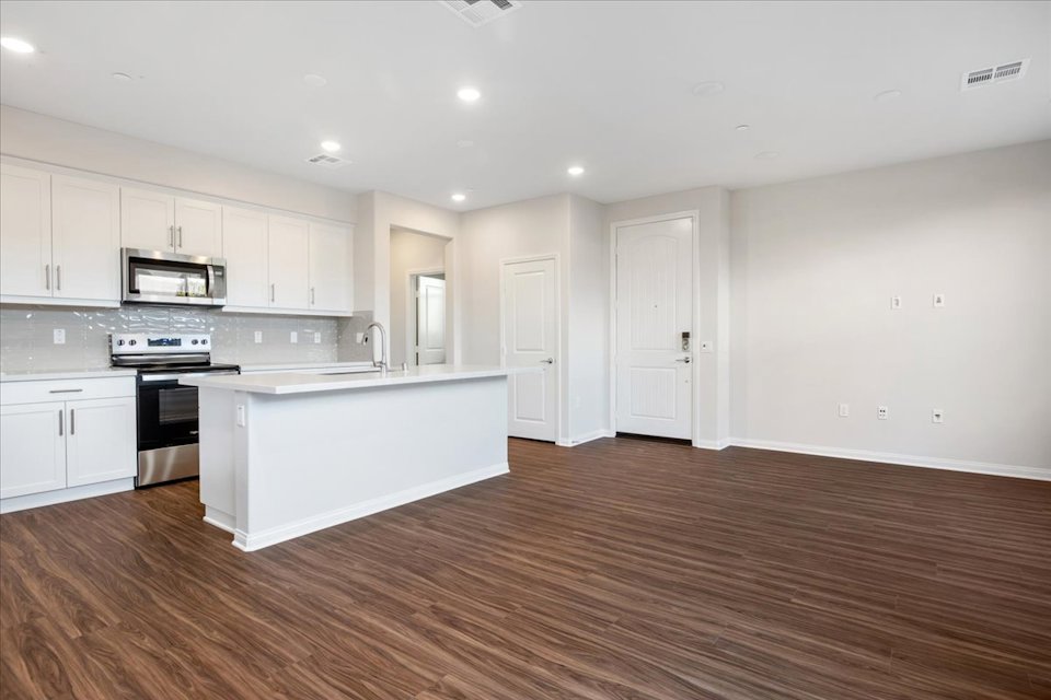 A kitchen with white cabinets.