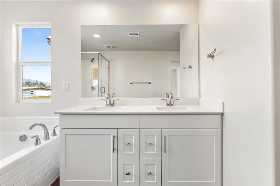 A bathroom with a large mirror.