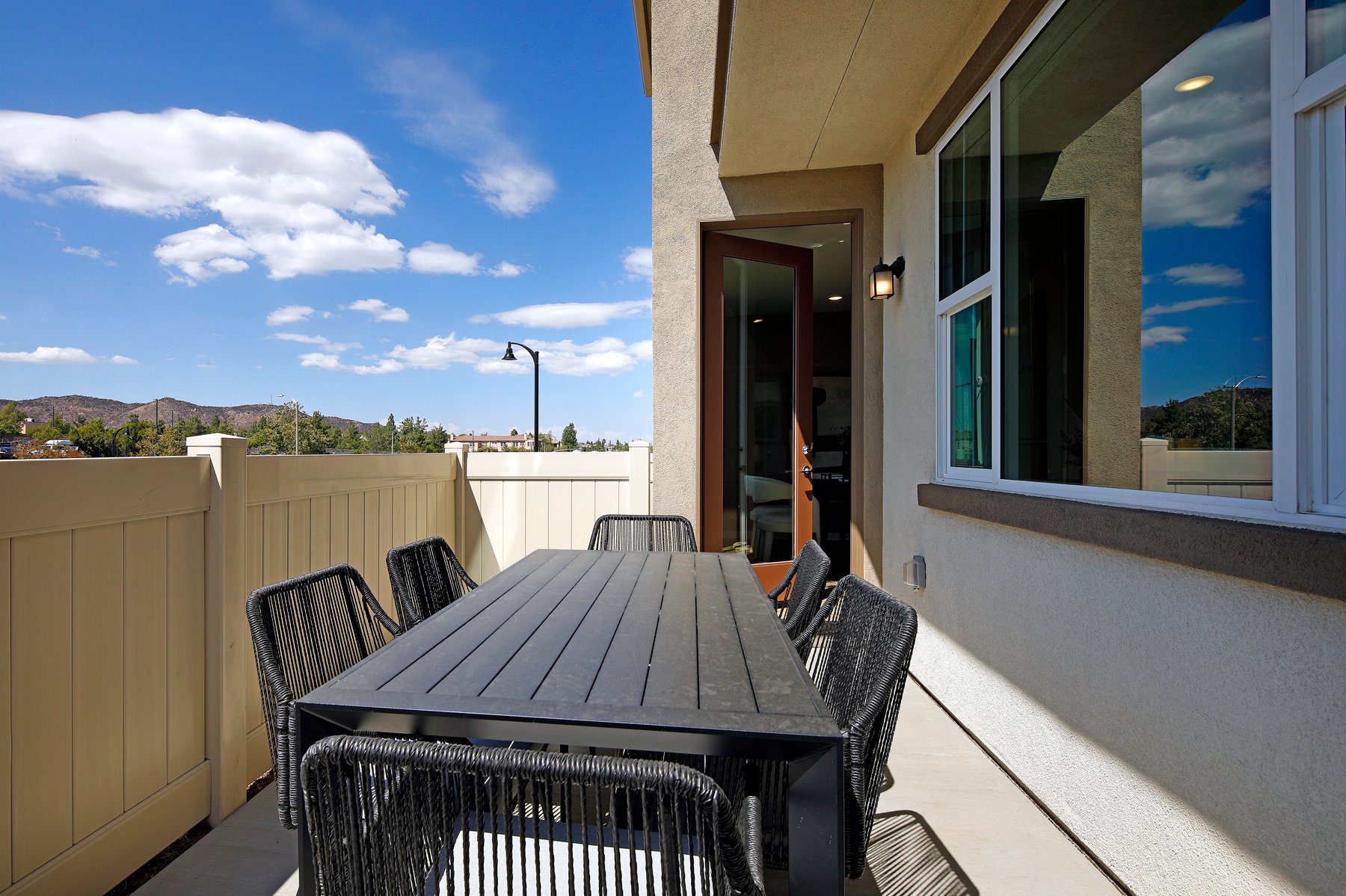 A table and chairs on a deck.