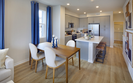 A kitchen with a dining table.
