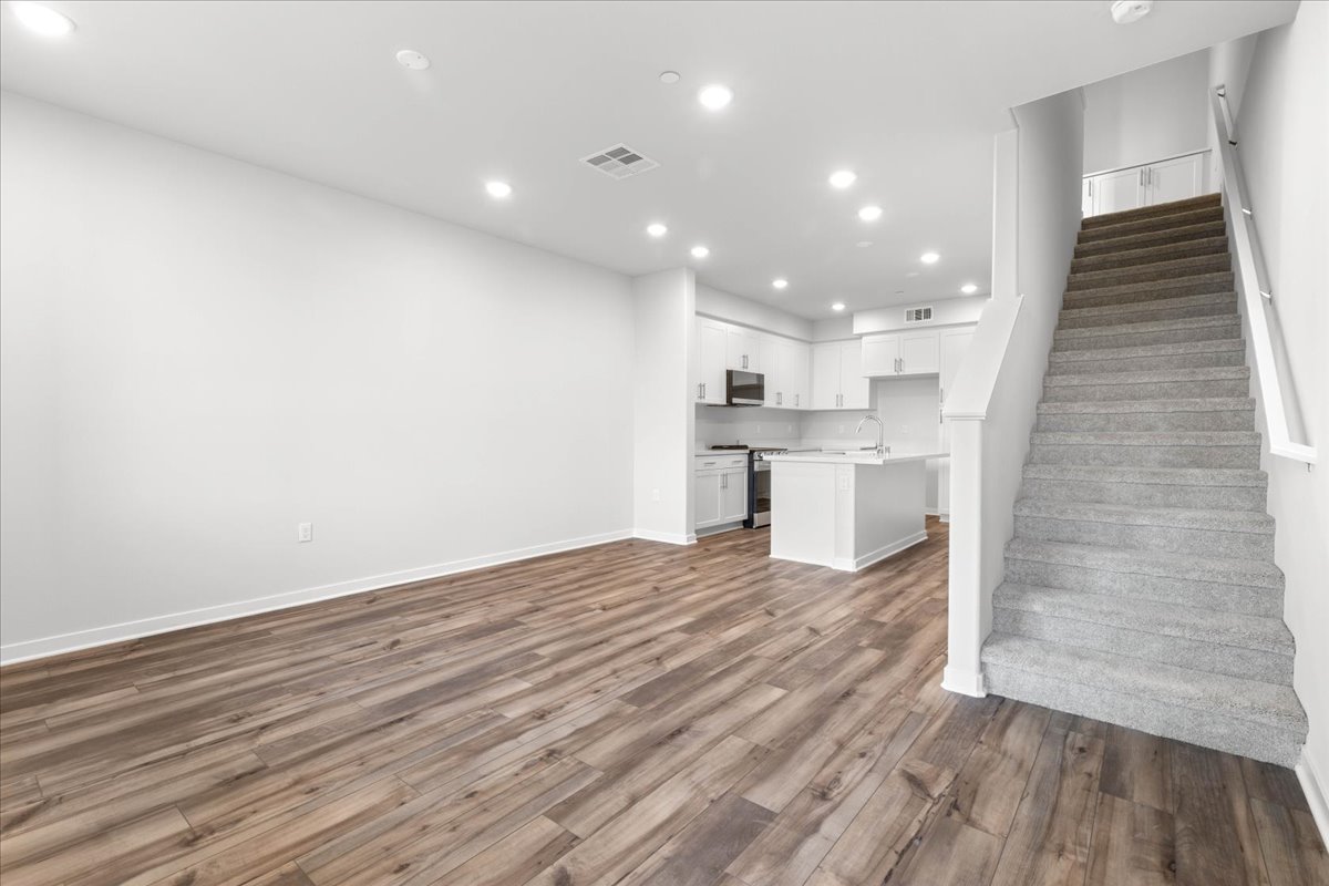 A large kitchen with wood floors.