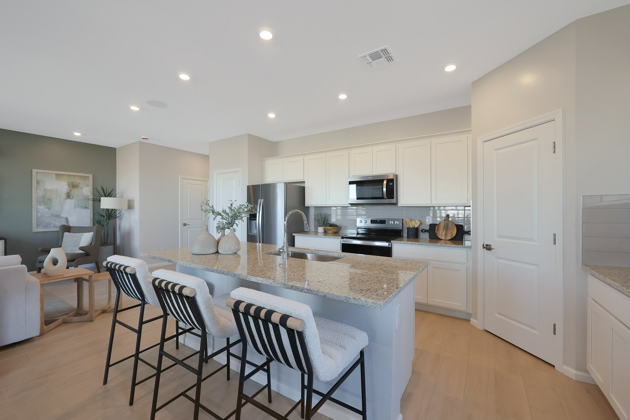 A kitchen with white cabinets.