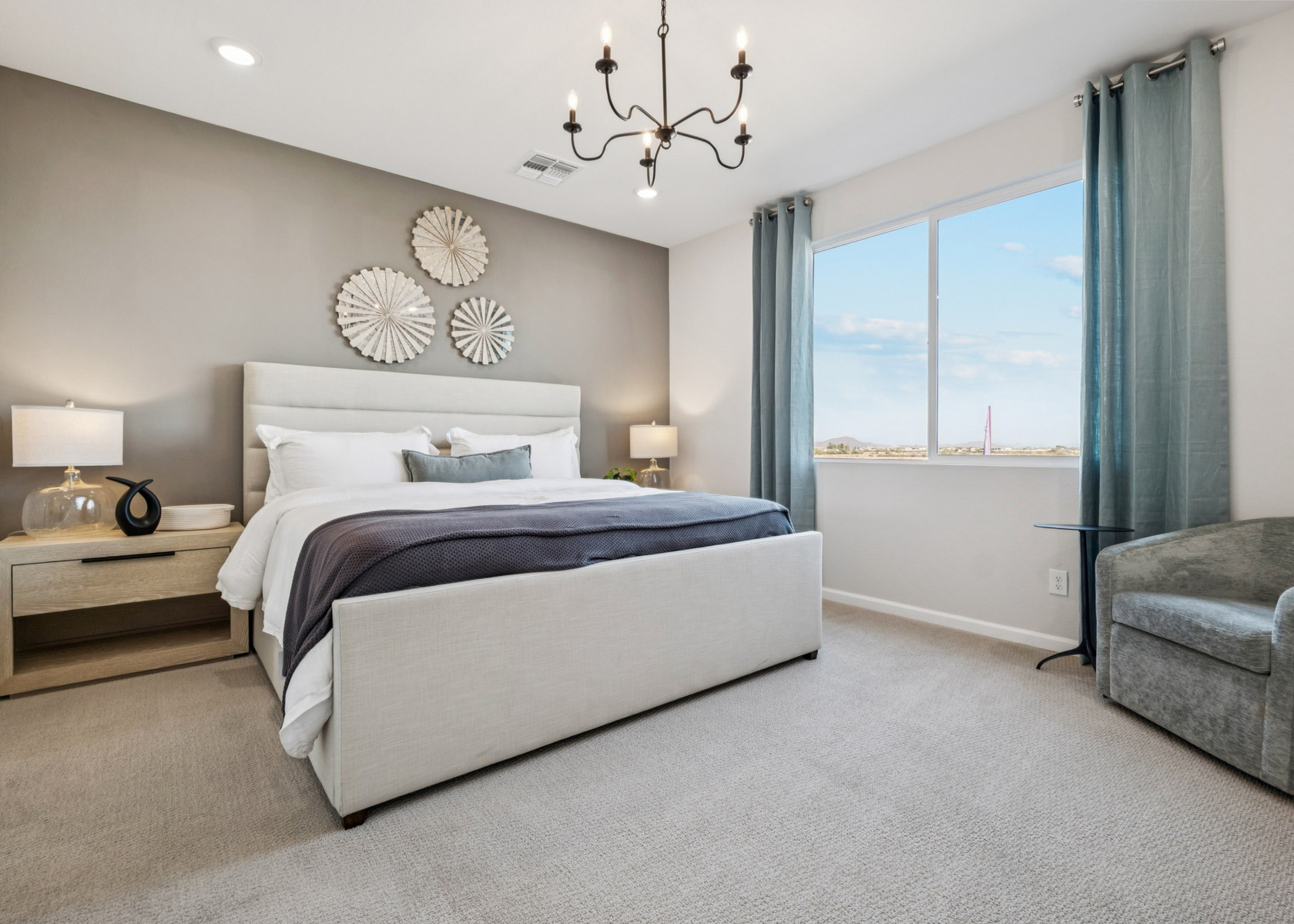 A bedroom with a large window.