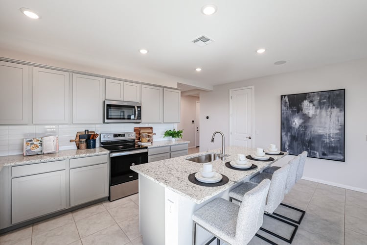 A kitchen with white cabinets.
