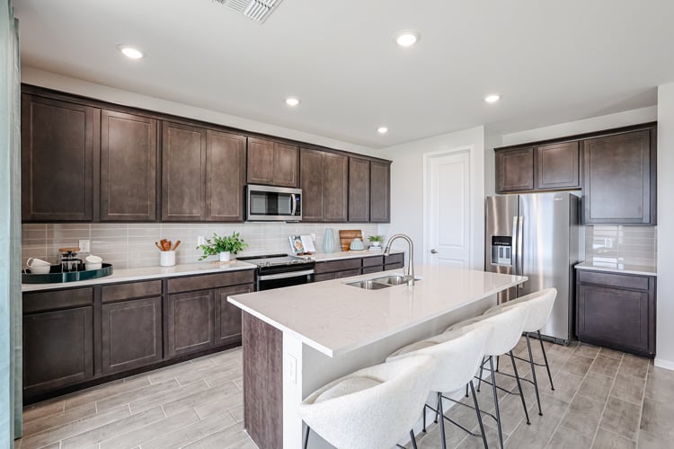 A kitchen with a table and chairs.