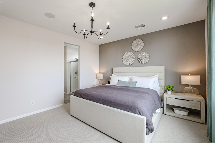 A bedroom with a bed and lamps.