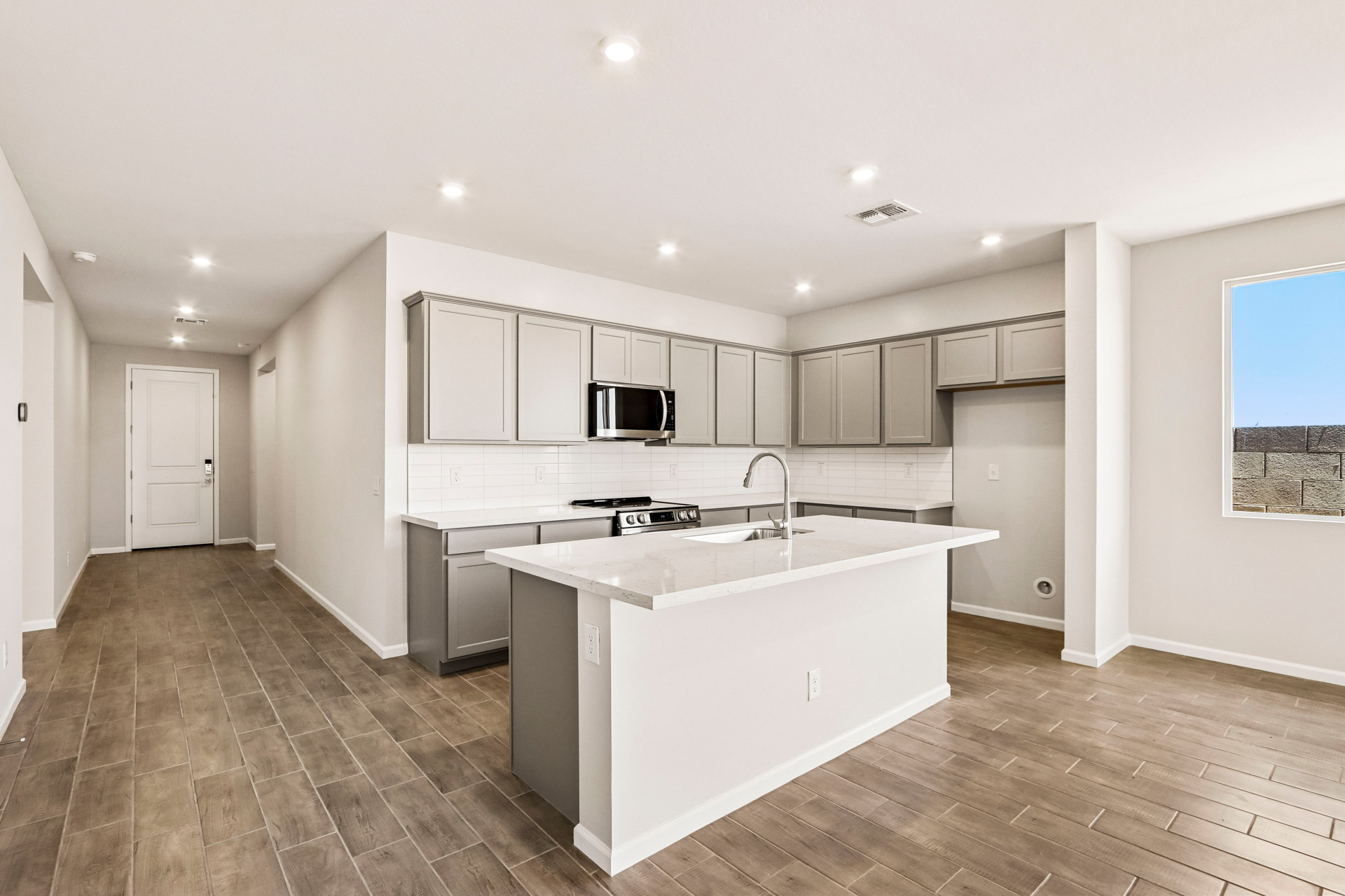 A kitchen with white cabinets.