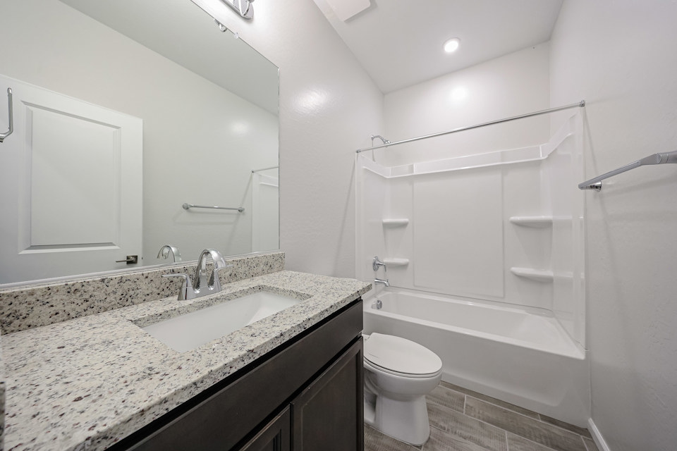 A bathroom with a marble countertop.