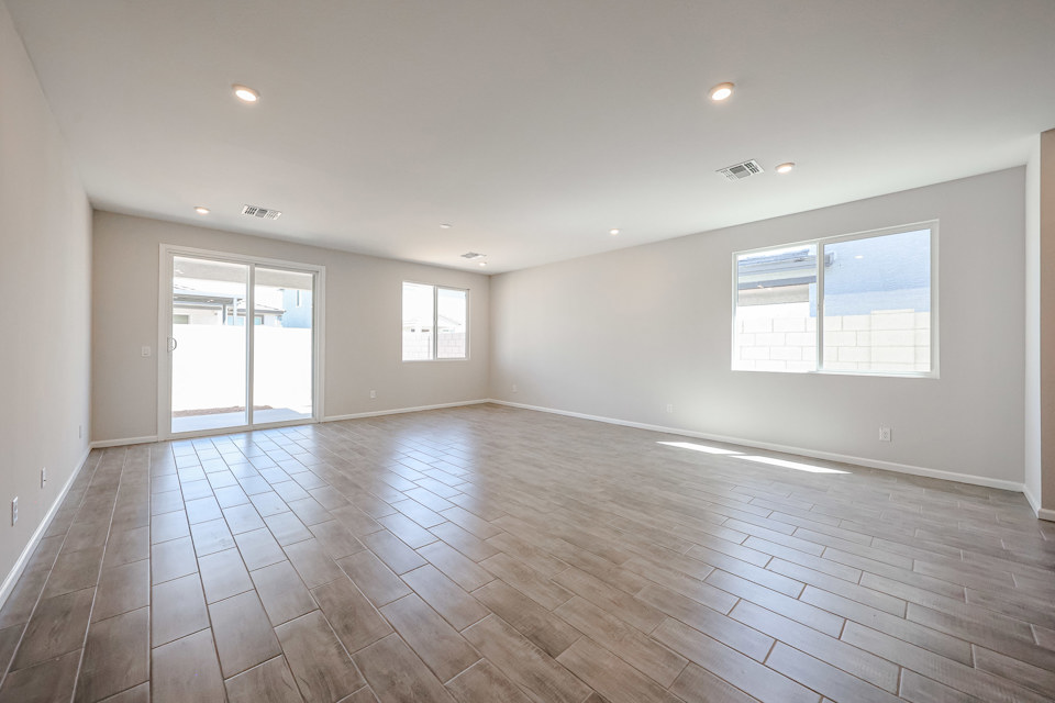 A room with a wood floor and windows.