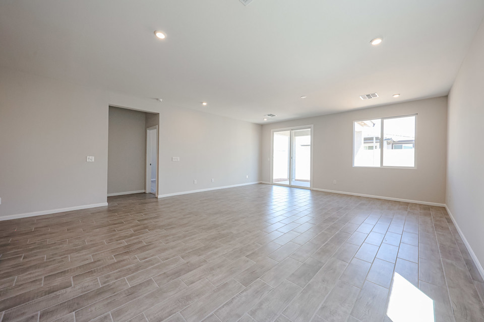 A room with a wood floor and windows.