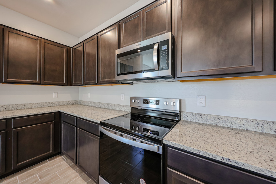 A kitchen with wooden cabinets.