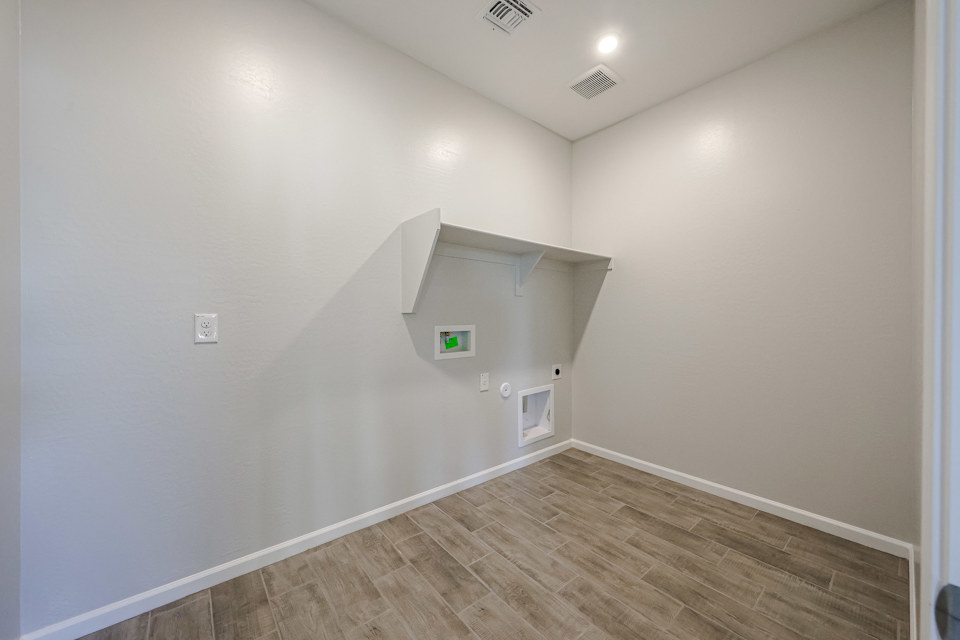 A hallway with a wood floor.