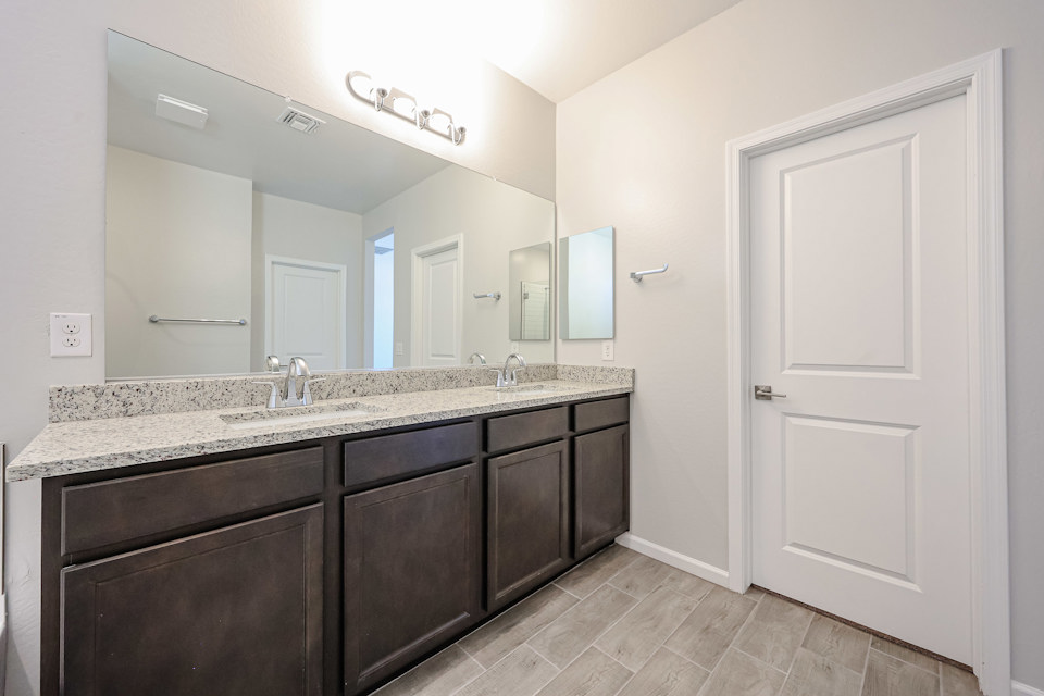 A bathroom with a large mirror.