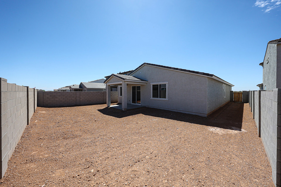 A house in a dirt field.