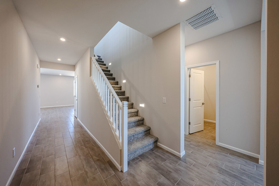A hallway with a wood floor.