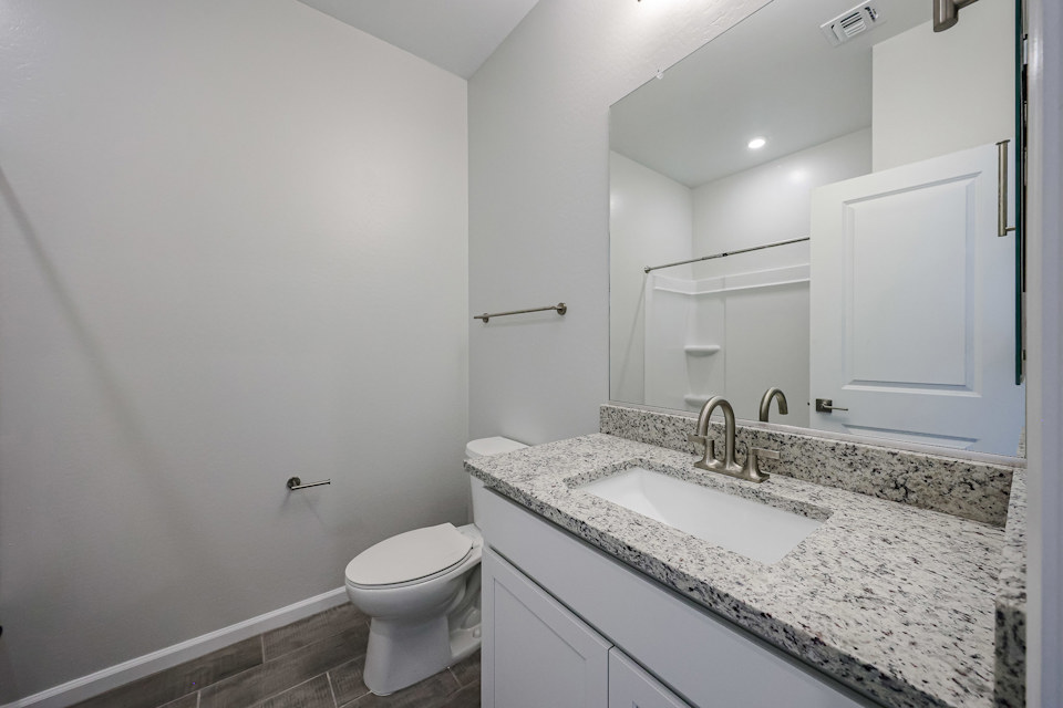 A bathroom with a marble countertop.