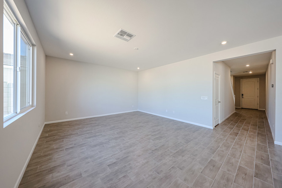 A room with a wood floor and windows.