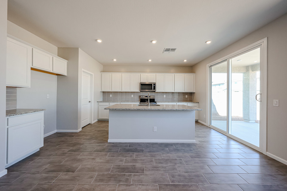A kitchen with white cabinets.
