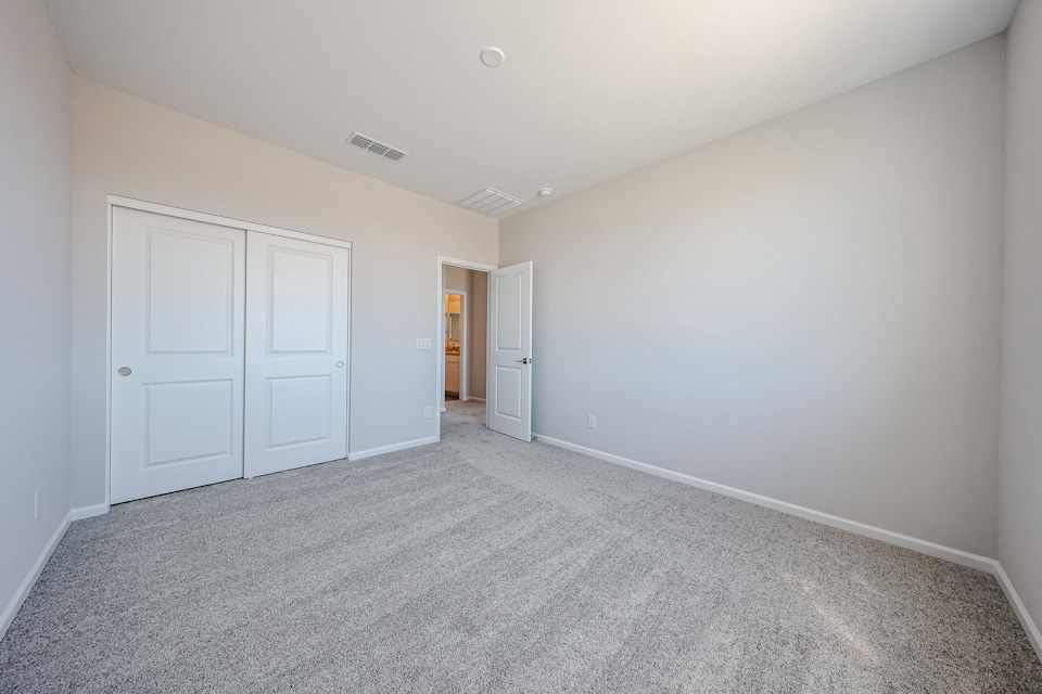 A hallway with white doors.