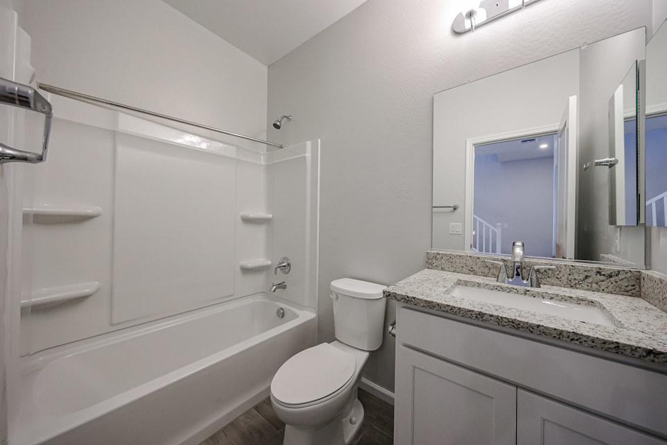 A bathroom with a tub toilet and sink.