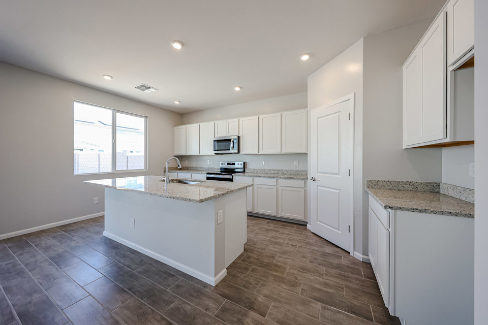 A kitchen with white cabinets.