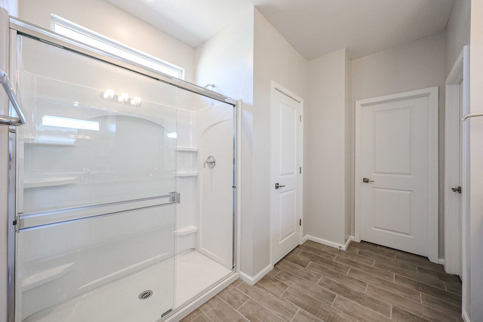 A bathroom with white doors.