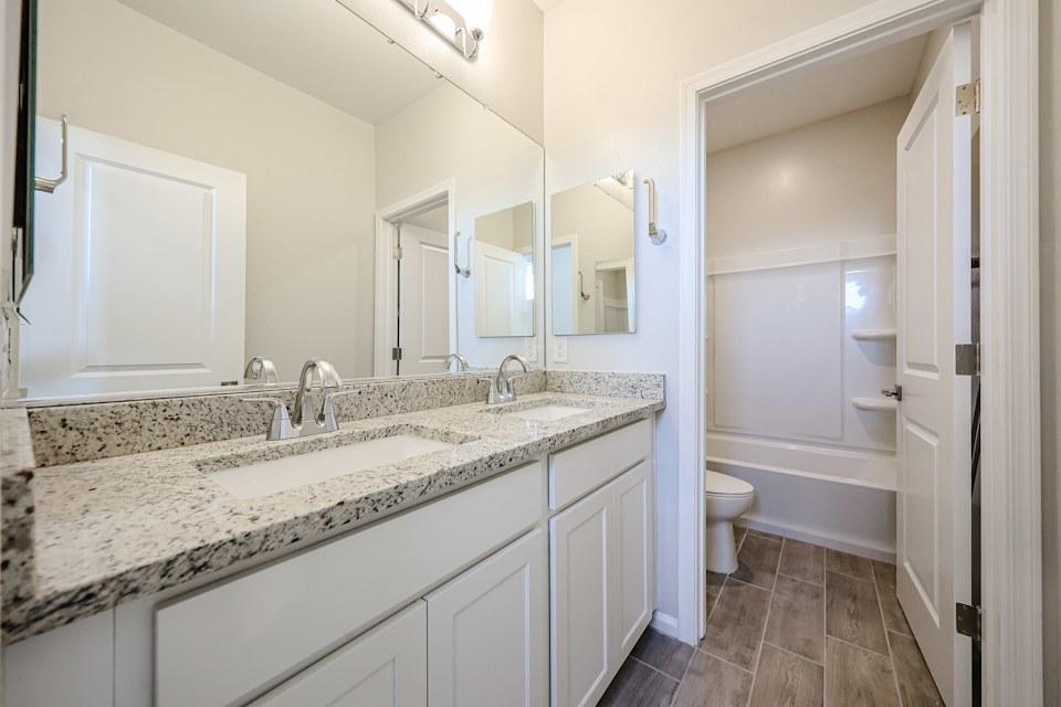 A bathroom with a marble countertop.