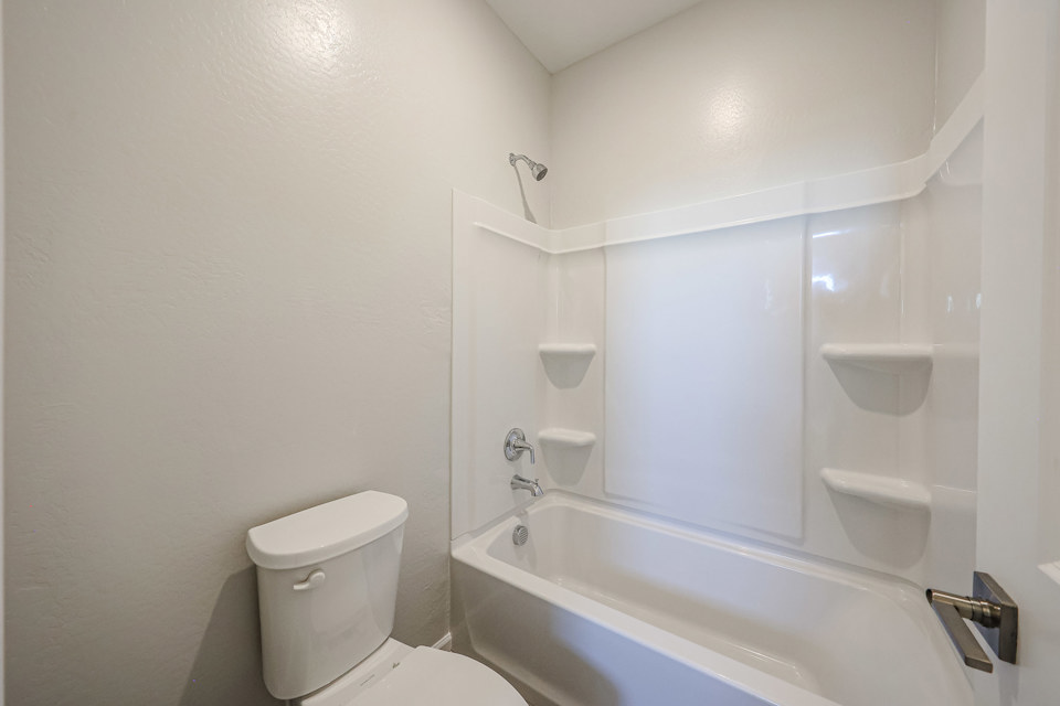 A bathroom with a tub toilet and sink.
