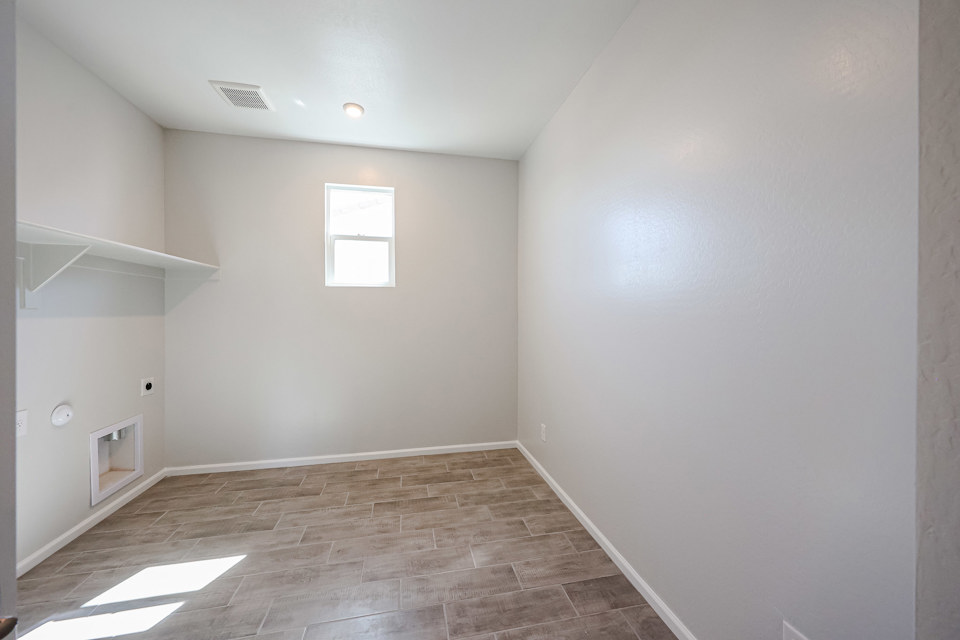 A room with a wood floor and white walls.