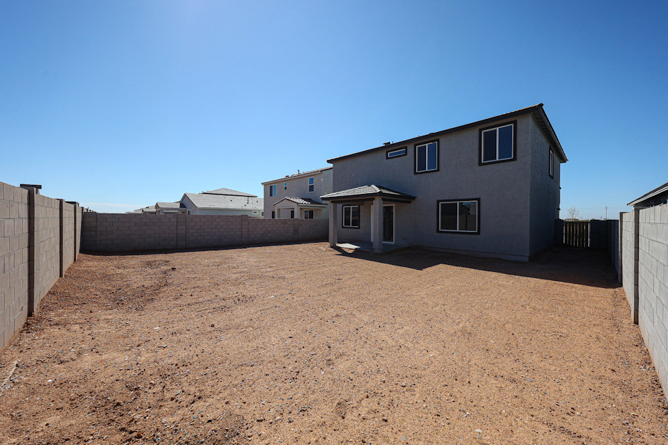 A house in a dirt field.