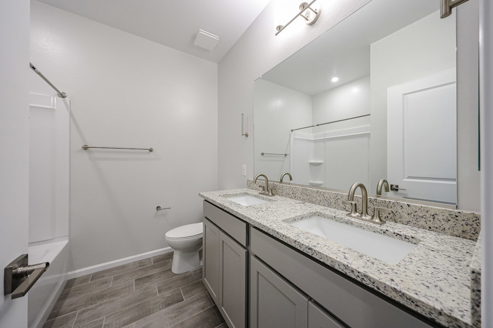 A bathroom with a large mirror.