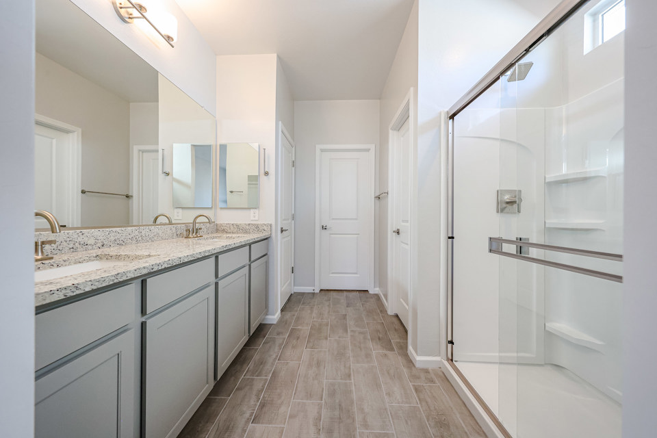 A bathroom with white cabinets.