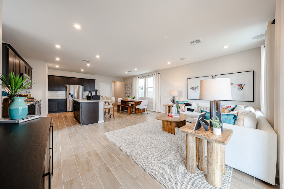 A large living room with a wood floor and white walls.