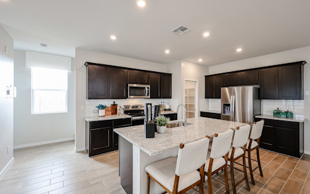 A kitchen with a dining table.