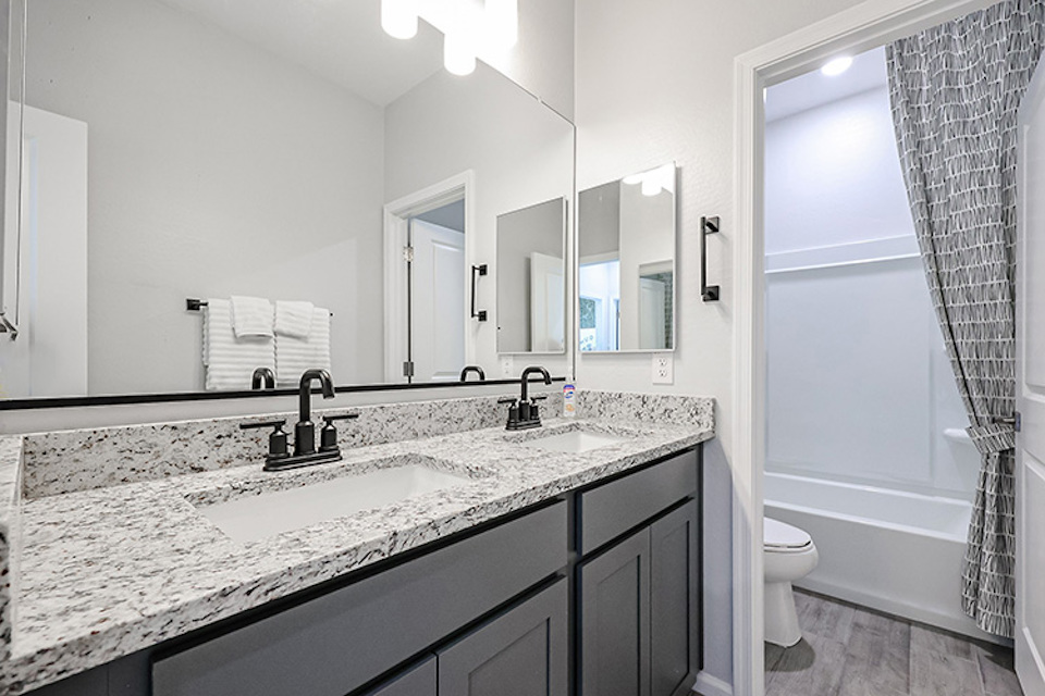 A bathroom with a marble countertop.
