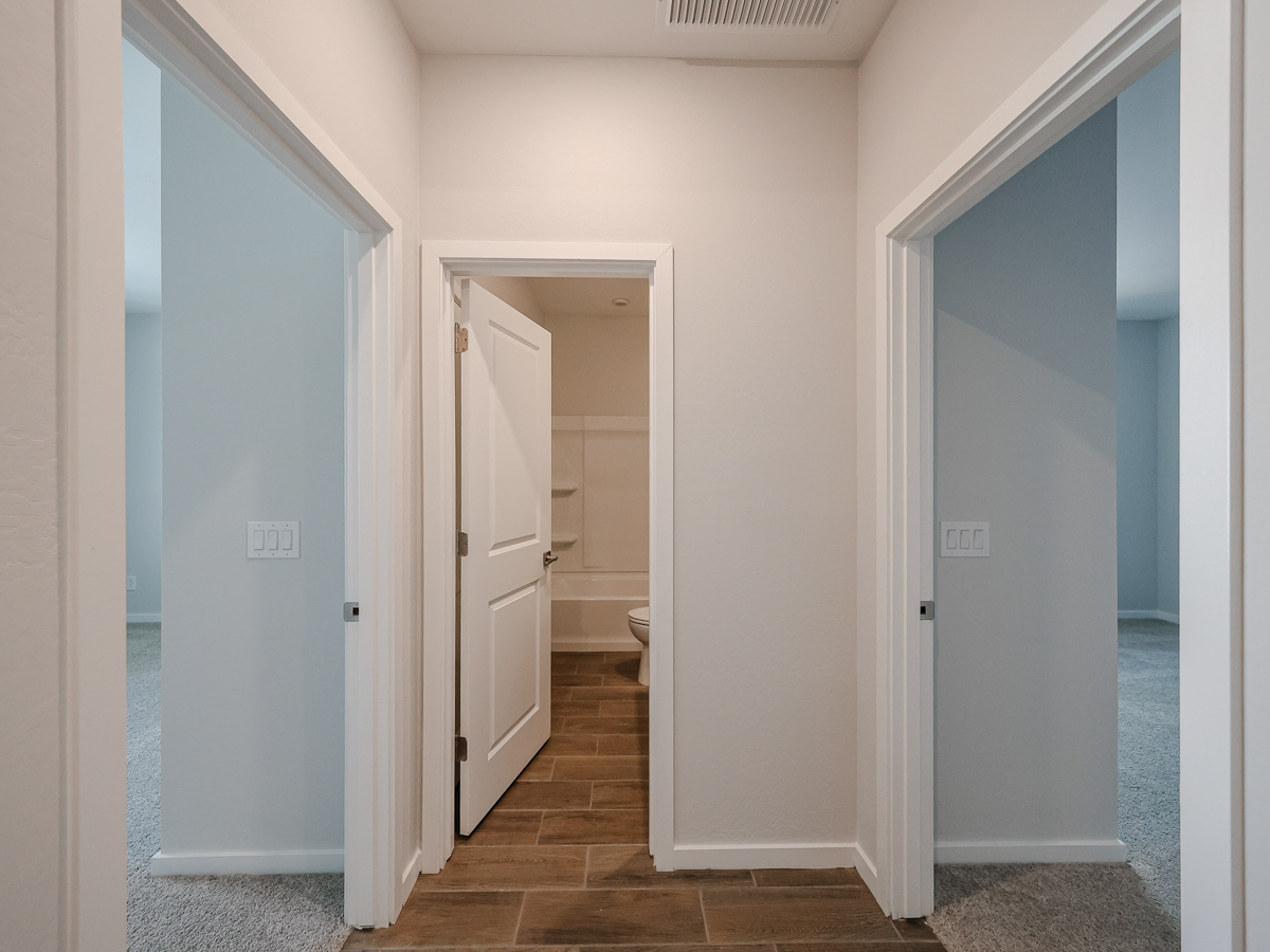 A hallway with white doors.