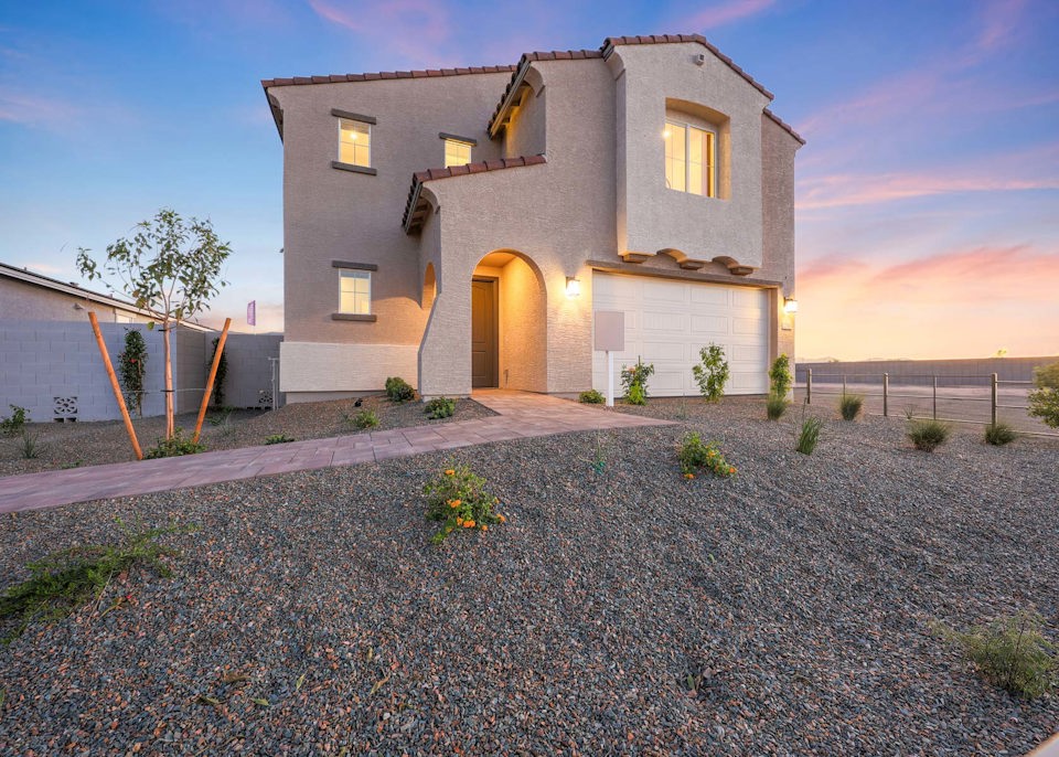 A house with a gravel driveway.