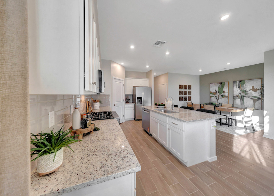 A kitchen with marble counters.