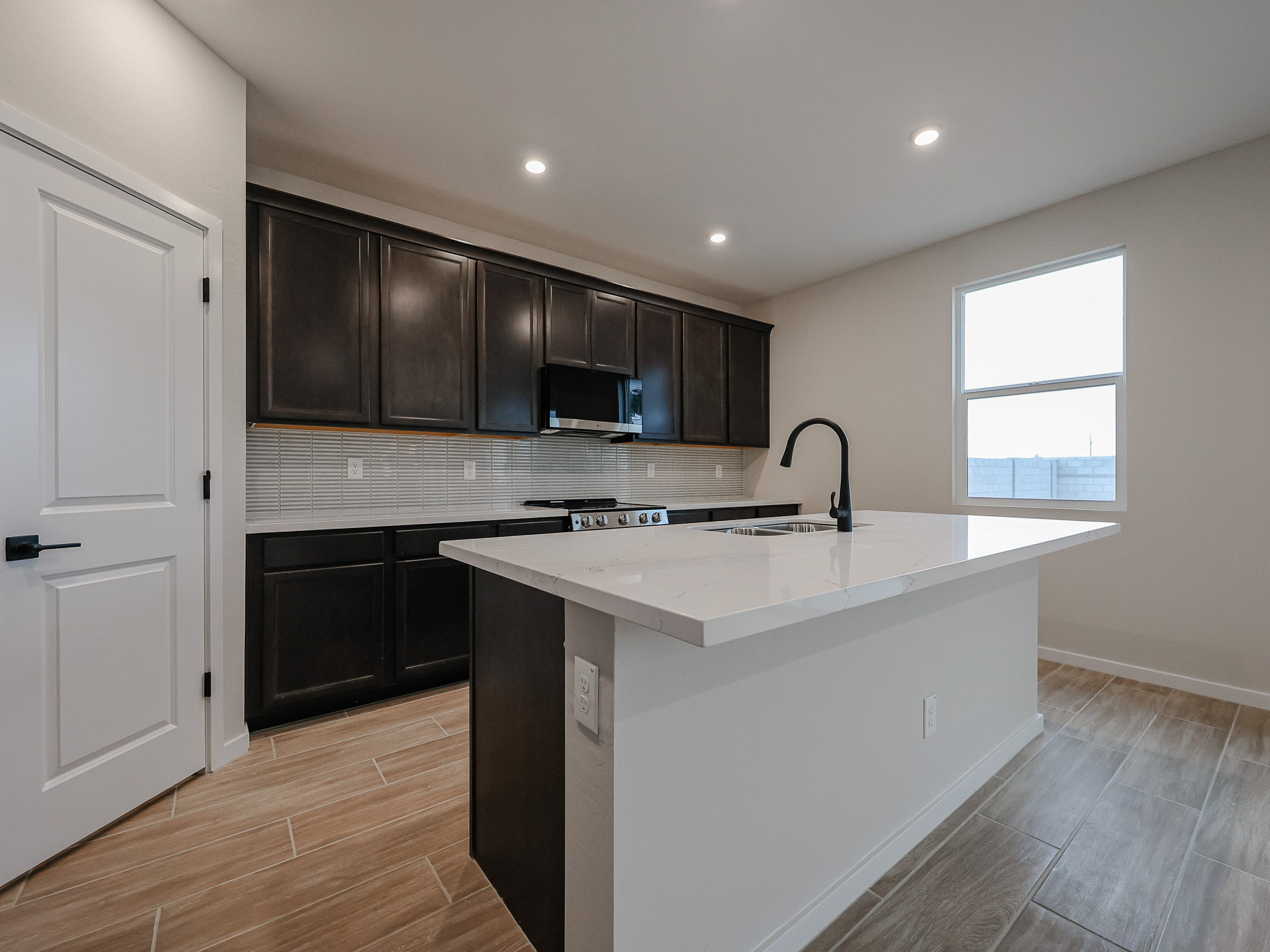 A kitchen with black cabinets.