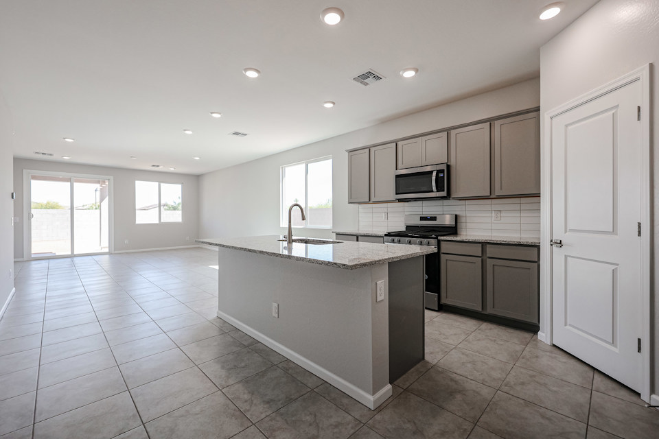 A kitchen with white cabinets.