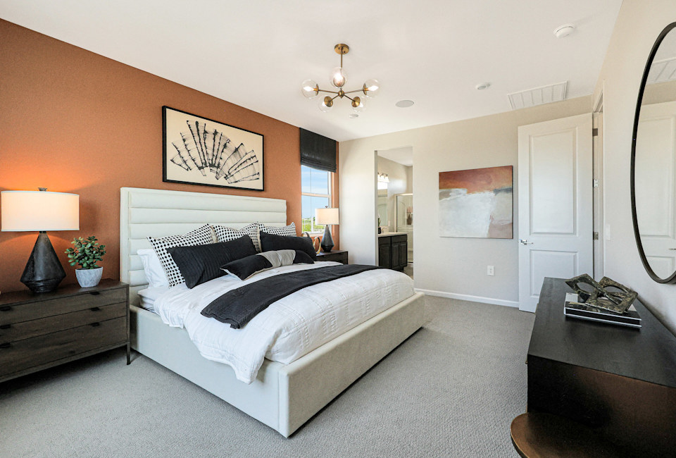 A bedroom with a bed and lamps.