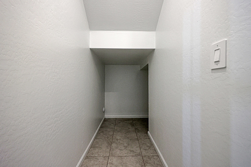 A hallway with white walls.