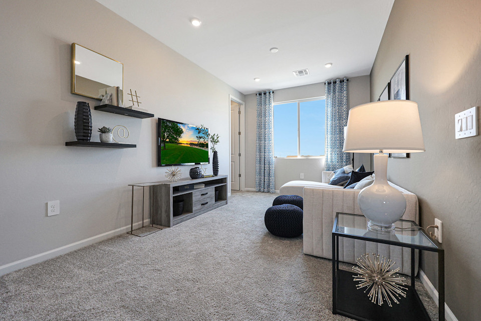 A living room with a tv and a lamp.