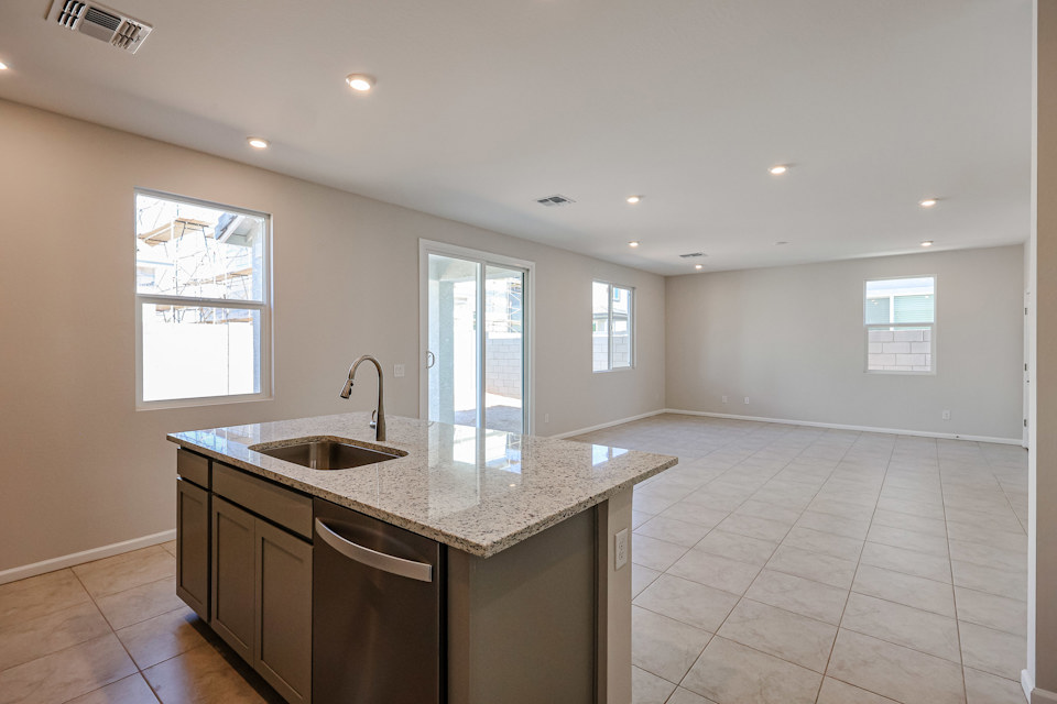 A kitchen with marble counters.