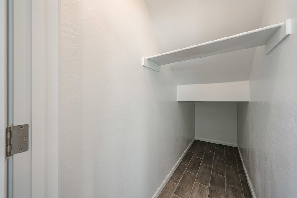 A hallway with white walls.