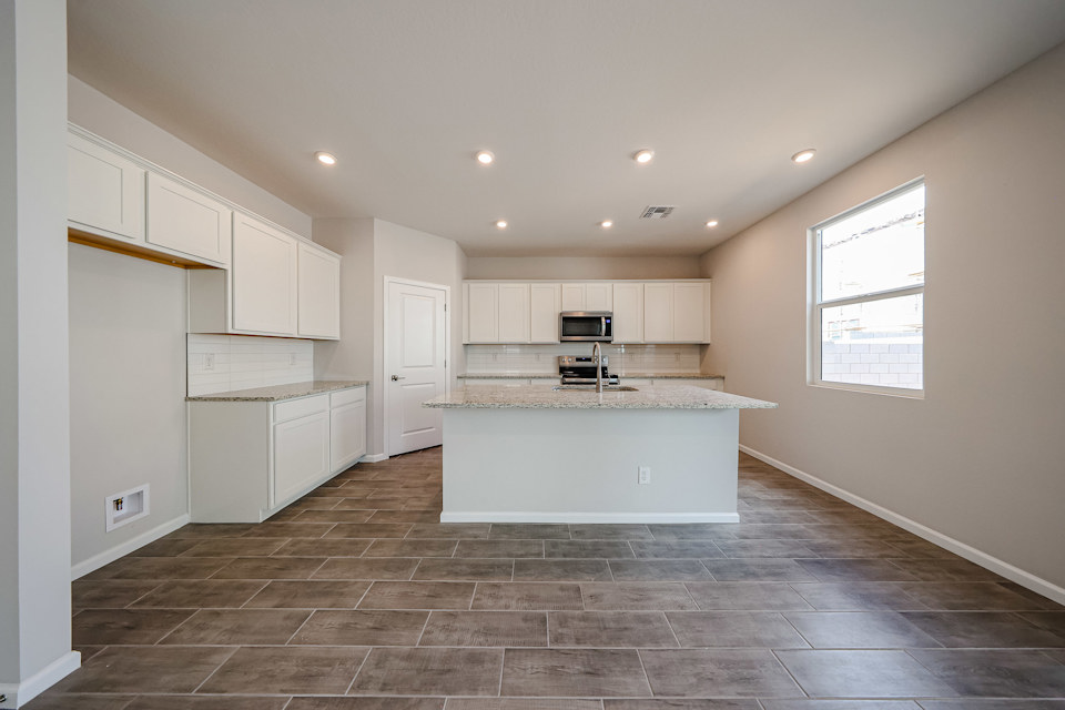 A kitchen with white cabinets.