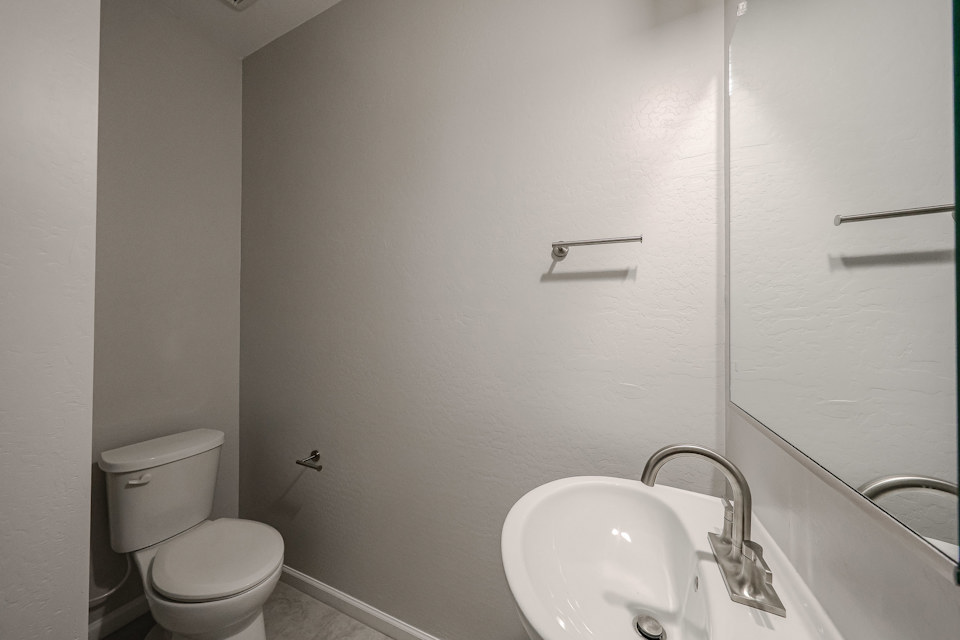 A bathroom with a toilet and sink.